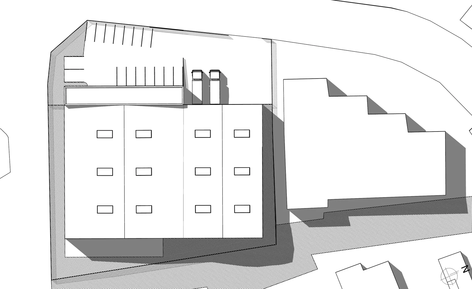 Plan de masse en noir et blanc montrant le volume de l'entrepôt et des bureaux dans son environnement, avec ombres portées.